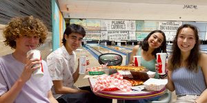 Teens eating pizza