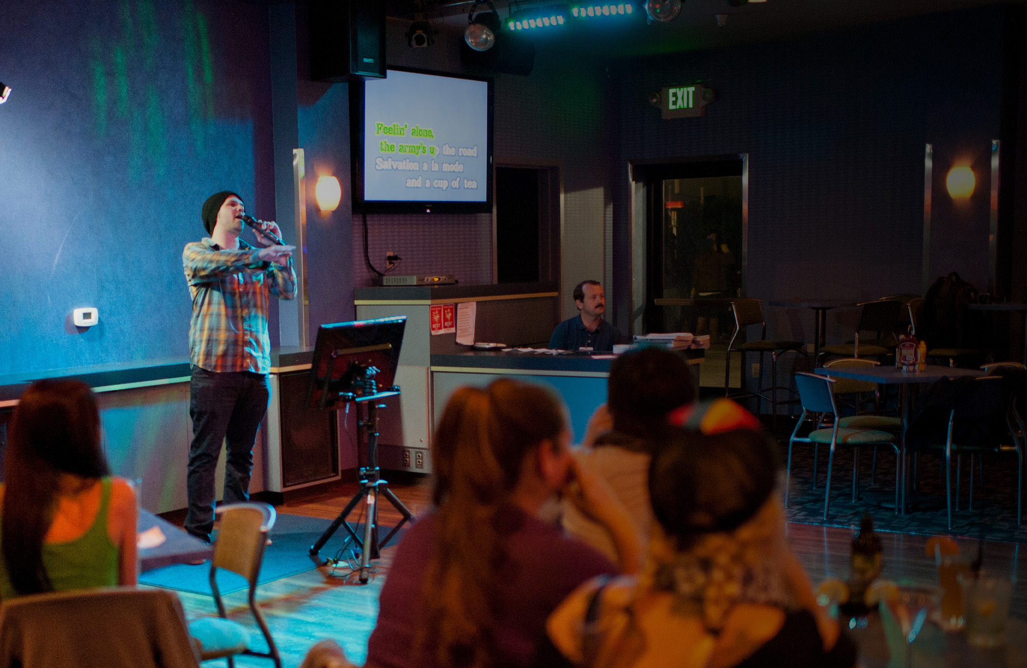 man singing Karaoke at Coasters